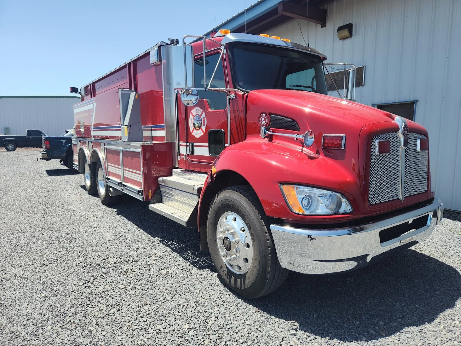 A red fire engine parked outside the shop building.